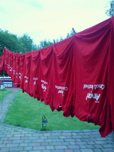 Line of festival sweatshirts on a washing line