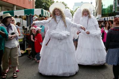 Two men dressed as huge angels on the towpath in voluminous white dresses