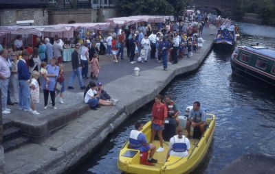 Stalls alongside wide towpath and canal. 1995