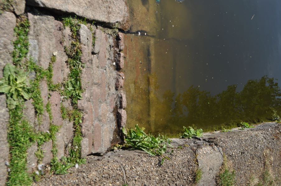 A ramp made of cobbles leads down into water