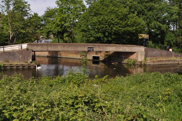 A footbridge over a river flowing into the canal