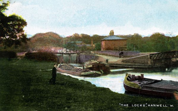 Footbridge over river with barges in the foreground