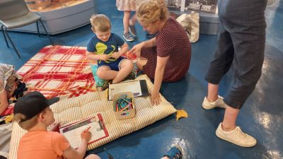 Children doing activities seated on rug